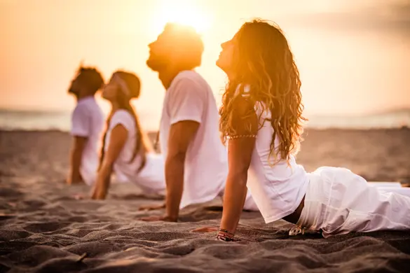 Yoga Class On The Beach At Sunset Gettyimages 1162496046