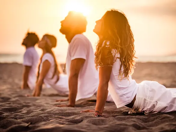 Yoga Class On The Beach At Sunset Gettyimages 1162496046