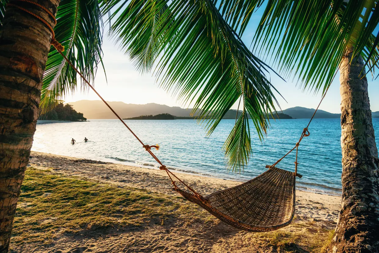 Hammock Between Two Palm Trees On The Beach At Sunset Gettyimages 1133353851