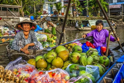 Roundtrip-Vietnam-South-Vietnam-Phu-Quoc-Day3-4-5-Can-Tho-Mekong delta-coconuts on floating marke-GettyImages-863617904-1.jpg