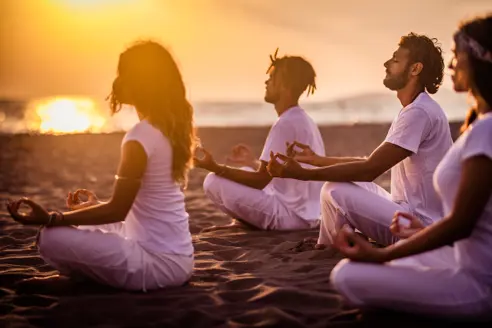 Yoga Class On The Beach At Sunset Gettyimages 1069556372