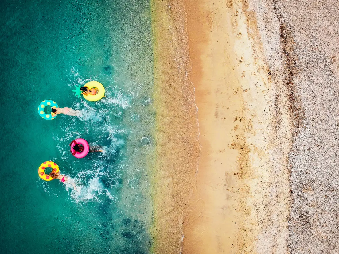 Beach With Swimming Donuts Gettyimages 993111380
