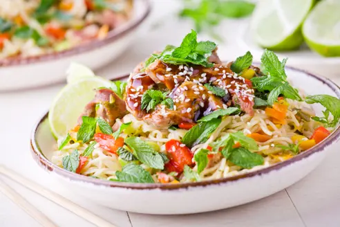 Bowl Of Thai Noodles With Pork And Fresh Vegetables Gettyimages 585773064